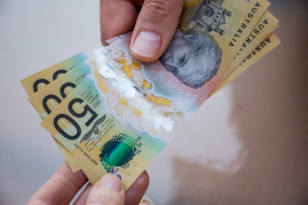 Hands holding australian dollars 50 banknotes. Finance help and payment concept.