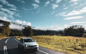 Car driving through country roads in Australia on a misty morning